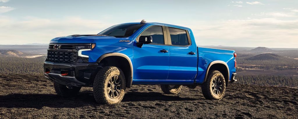 A blue 2025 Chevrolet Silverado 1500 pickup truck parked in the outdoors.